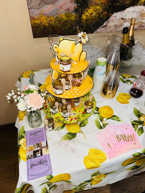 Decorative table setting with a lemon-themed cake and baby shower decorations.