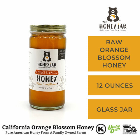 Jar of raw orange blossom honey with The Honey Jar branding on a white background