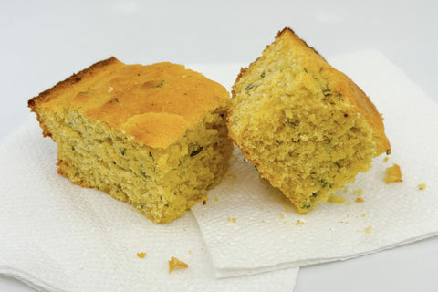 Honey herb cornbread on white napkin on white background