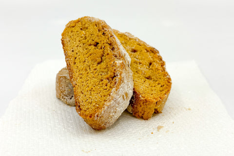 Sliced honey biscotti on white napkin on white surface