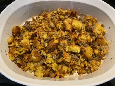 Honey herb cornbread stuffing in white baking dish