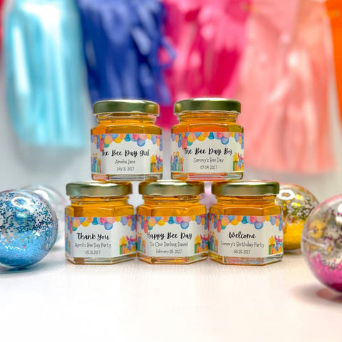 Jars of honey with personalized labels on a colorful background