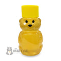 2 oz honey bear shown with yellow lid and filled with honey.