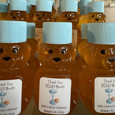 Bears with honey and blue caps, featuring personalized labels for a baby shower.