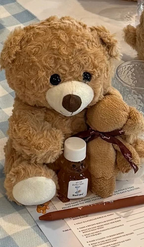 Teddy bear with small bear-shaped jar of honey