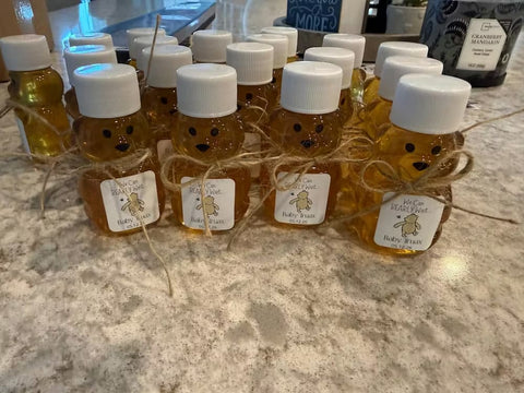 Bottles of honey with bear faces on a countertop