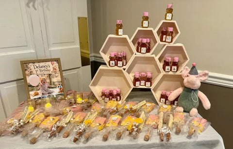 Honey bears on honeycomb shaped shelf in front of bags of treats on table