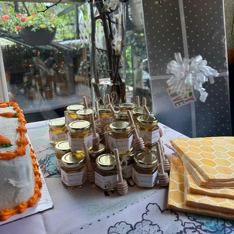 Favor table with honey jars, cake, and napkins