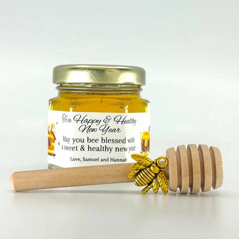 2 oz  honey jar favor with gold lid, 3" wooden honey dipper, gold bee charm, and personalized honey-themed design on label with To a Happy & Healthy New Year as the title.