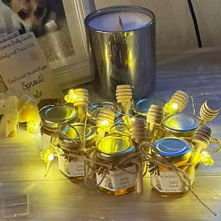 String lights with jars and lids on a surface, with a candle and photo frame in the background.
