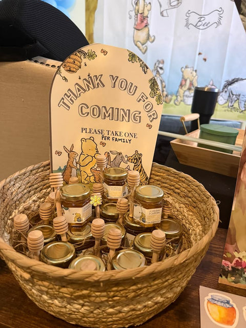 Basket filled with honey jars and a sign