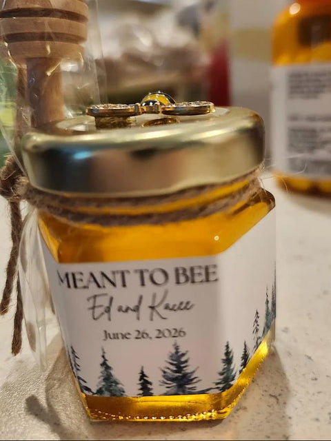 Honey jar with label and honey dipper on countertop
