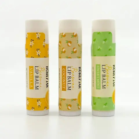 Three lip balms with different flavors on a white background