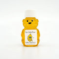 2 oz Winnie the Pooh honey bear baby shower favor with white cap and personalized label. Label shows classic Winnie the Pooh hugging a honey pot with the title Our Little Bear.