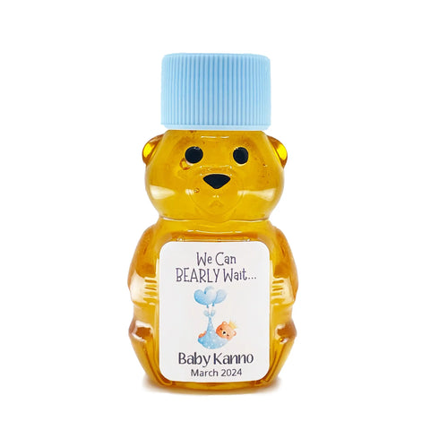 2 oz honey bear baby shower favor with baby blue cap and personalized label. Label shows a dreaming bear in a blue blanket with the title We Can Bearly Wait.