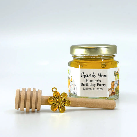 2 oz hexagon jar filled with honey, gold lid, 3" wooden honey dipper, gold flower charm, and personalized jungle animal party design on label with Thank You title.