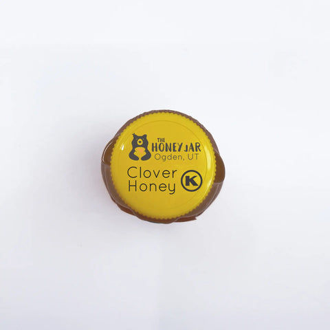 Top of jar features kosher label with Kosher symbol and the following wording: The Honey Jar Ogden, UT Clover Honey.