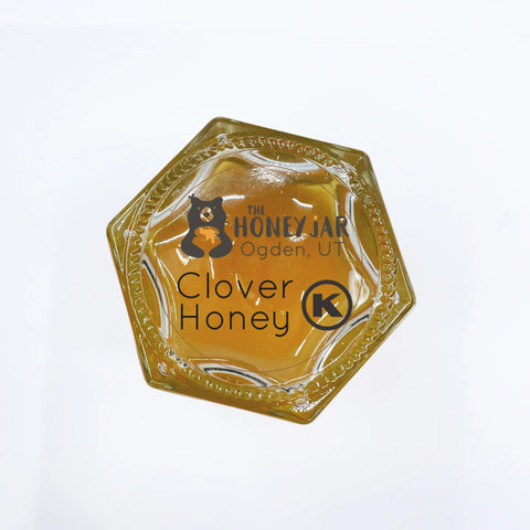 Bottom of jar features kosher label with Kosher symbol and the following wording: The Honey Jar Ogden, UT Clover Honey.