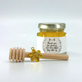 2 oz hexagon jar filled with honey, gold lid, 3" wooden honey dipper, gold flower charm, and rose laurel design on label with title Thank you for sharing our bee-utiful day with us.