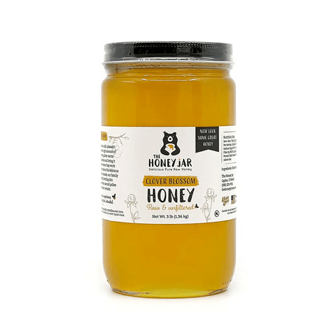 Jar of The Honey Jar brand honey with a label on a white background