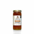 Jar of honey with 'The Honey Jar' label on a white background