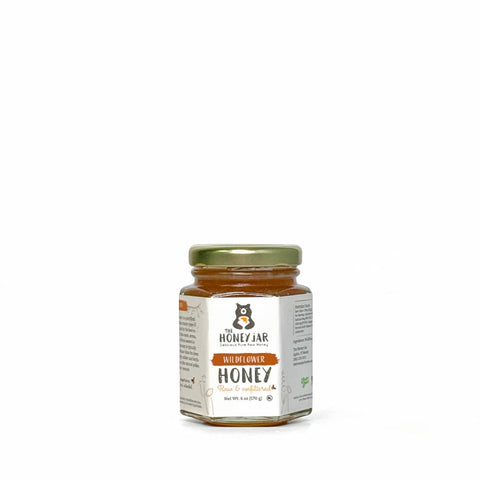 Jar of honey with a label on a white background