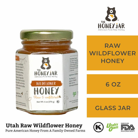 Jar of raw wildflower honey with 'The Honey Jar' branding on a white background