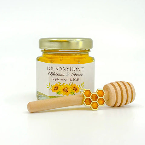 Honey favor set with gold lid, personalized sunflower bunch label, 3" wooden honey dipper, and enamel honeycomb charm. Label title is Found My Honey.